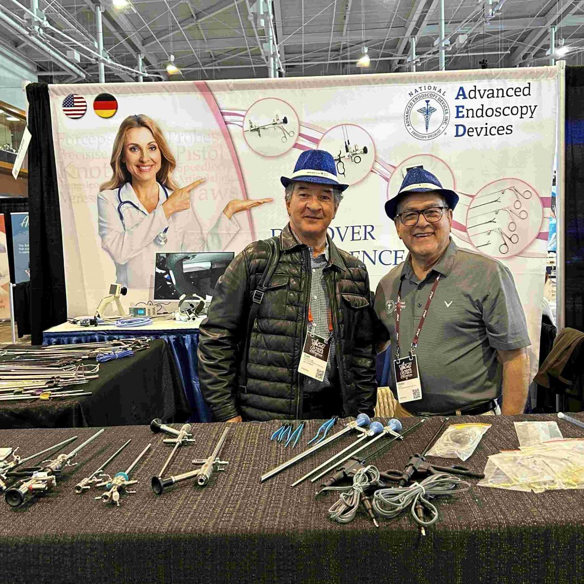 Advanced Endoscopy Devices at AAGL 2023 Photos Nashville - Two men taking a photo infront of banner